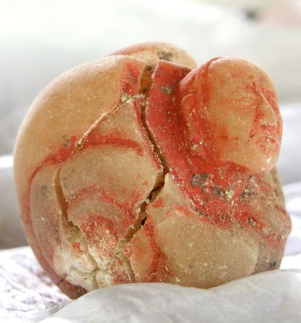 A small alabaster jar depicting an old woman was found in the tomb.