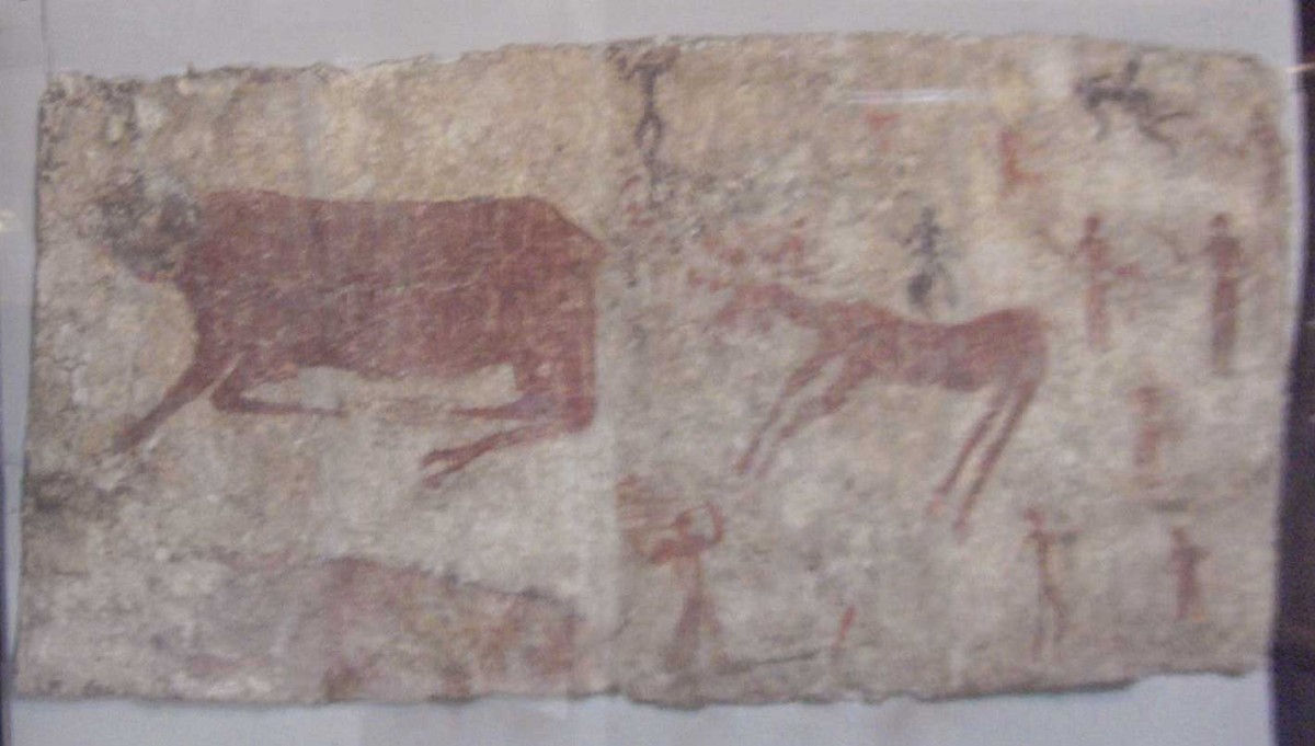 Wall painting of a bull, deer and man from Çatalhöyük, 6th millennium BC. Reconstruction of the bull's heads and the human relief-figure. Museum of Anatolian Civilizations, Ankara, Turkey.