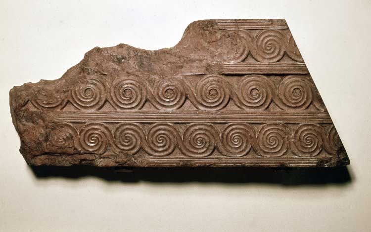 Fragment of red marble (rosso antico), from the façade of the Treasury of Atreus. British Museum.