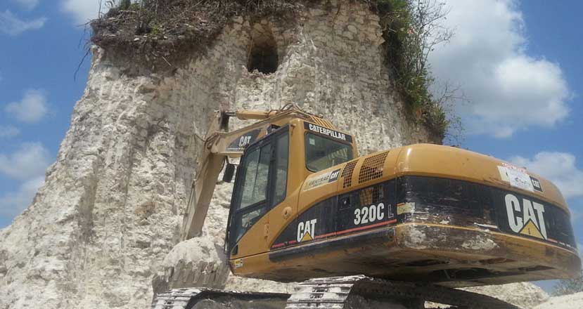 Ruined - a chamber becomes visible as the excavator rips open the Maya mound. Image: Jules Vasquez / Past Horizons.