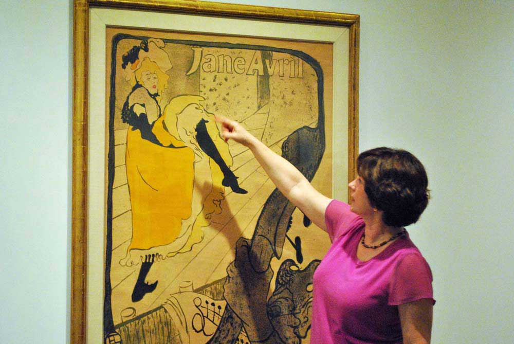Curator Diane Fischer points out a detail.
