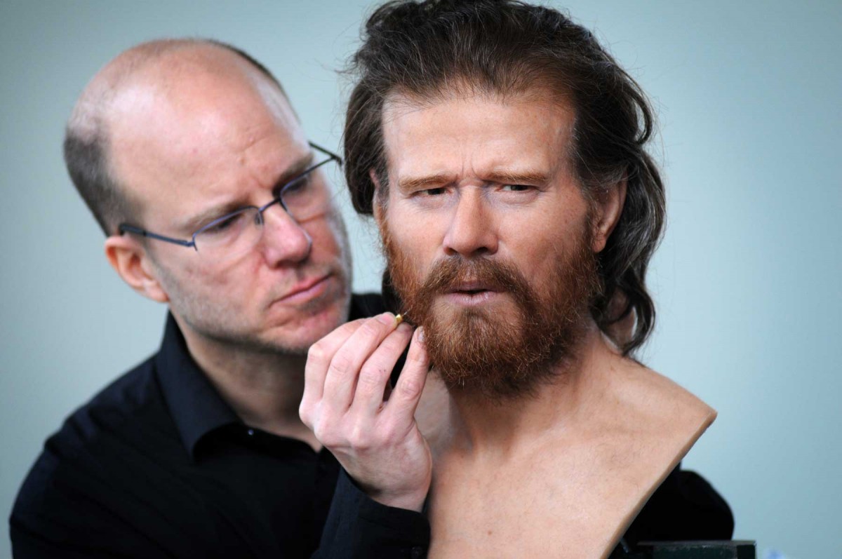 Sculptor Oscar Nilsson puts the finishing touched to a head reconstructed from a male neolithic skeleton unearthed near the site. Photo: National Trust Press Office