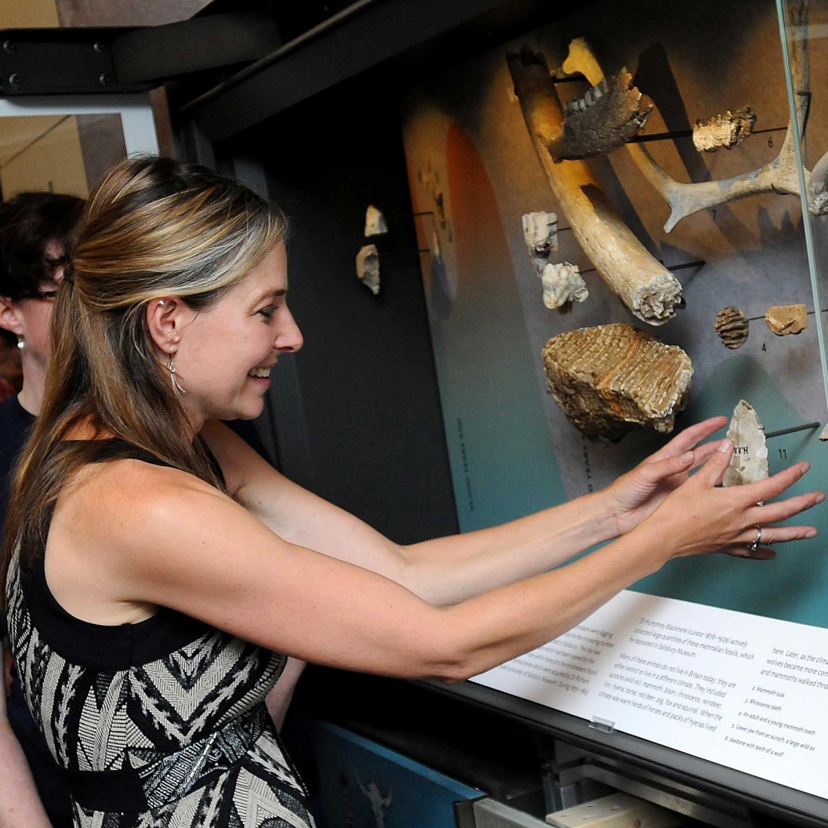Professor Alice Roberts places the last object in the gallery. Photo: Salisbury Museum