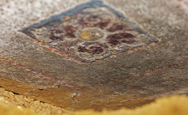 Amphipolis: At the lower part of the slab painted decoration in blue, red and yellow colour was found, picturing coffers with rosettes in the center.