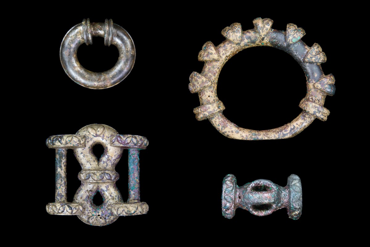 Fig. 5. Selection of chariot fittings: miniature terret ring (upper left), large terret ring (upper right), strap junction (lower left) and barrel-shaped harness fitting. Credit: University of Leicester. 