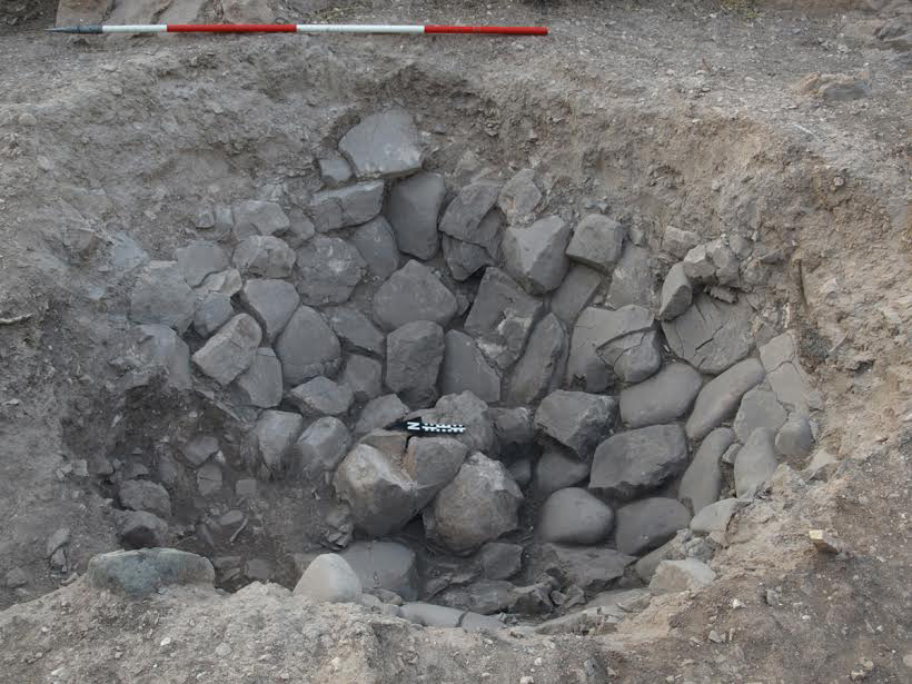 Fig. 1. Large stone-lined pit that showed evidence of burning and was filled with a concentration of ash.