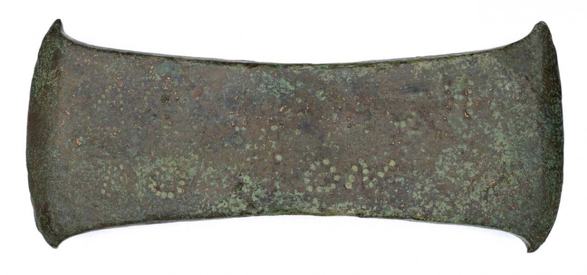Fig. 7. Cast-bronze double axe with an ellipsoid hole for the shafting of the handle. The axe dates back to the Late Bronze Age, while bearing votive inscription from the Classical period. (Source: Benaki Museum)