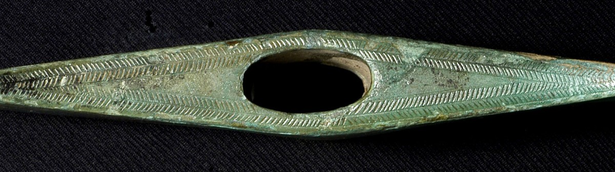 Fig. 7. Herringbone decoration on surface of cast bronze double axe of the Late Bronze Age, having oval shaft hole, from the hoard at Stefani in Preveza. (Source: author’s archive)