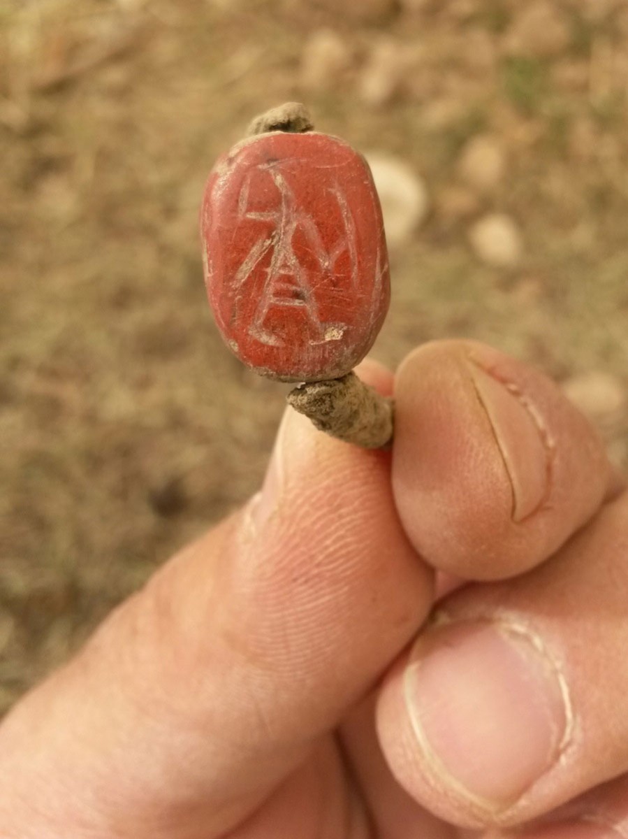 A ring unearthed during the excavation is inlaid with a seal showing an Egyptian warrior holding a shield and sword. 
Photo Credit: Unit for the Prevention of Antiquities Robbery - IAA.