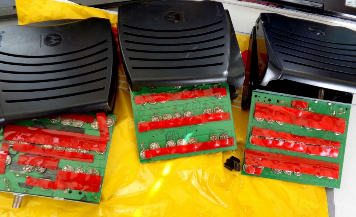 The coins had been attached with tape on the router circuit board. Photo Credit: Bulgarian Customs Agency.