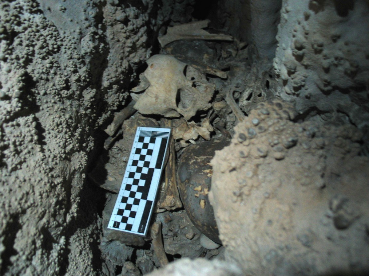  A crevice in the cave where human remains, including the skull of a child, can be seen. Credit: Image courtesy of University of Granada.