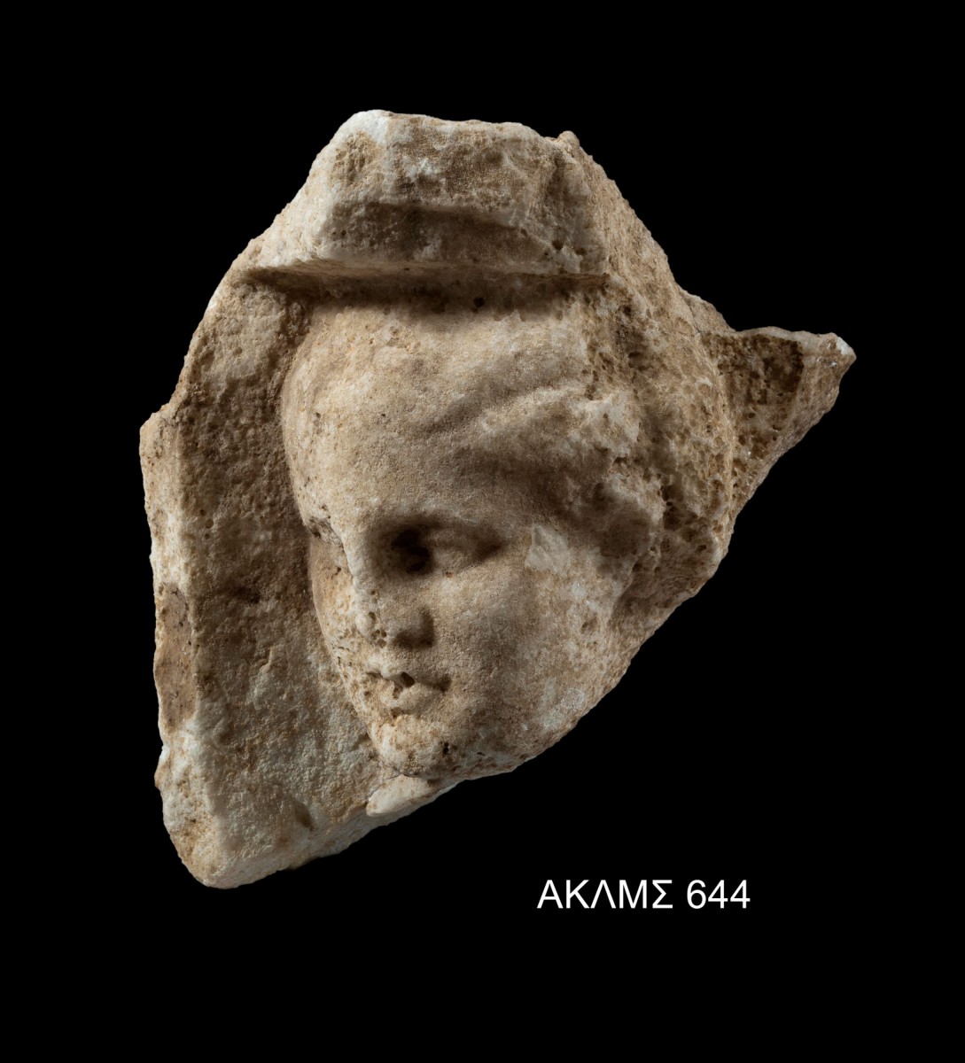 Coffer panel decorated in relief with a male head. From the ceiling of the porch of the Hall of Choral Dancers. 340-330 BC. Credit: Acropolis Museum
