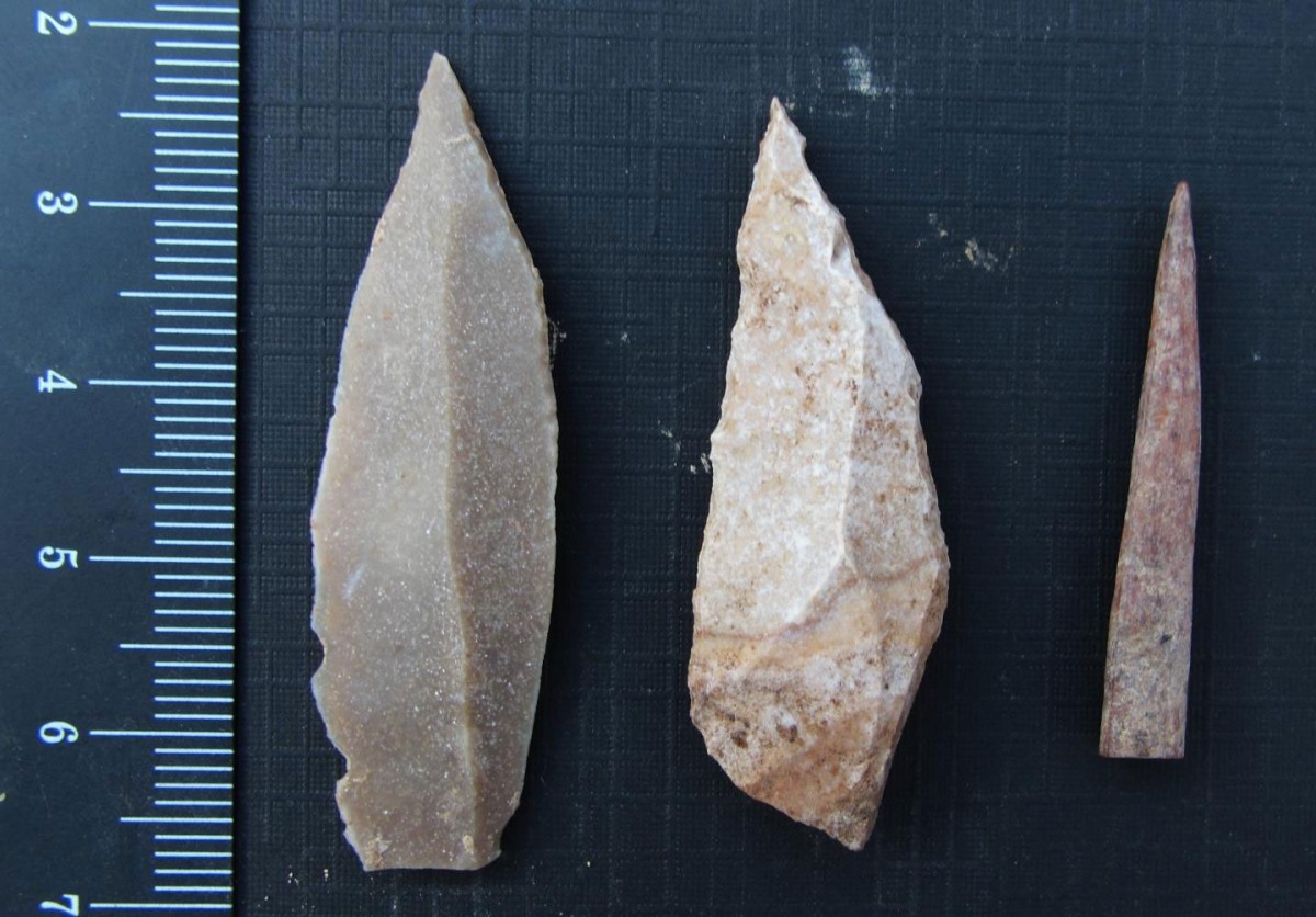 Two stone tool points were made using a prismatic blade technique (left and center), and a bone point or needle (right).
Credit: Photo by Aaron Stutz, Emory University.