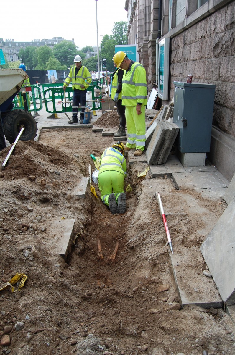 Workers at the site carefully digging out the skeletons. Photo Credit: The Press and Journal.