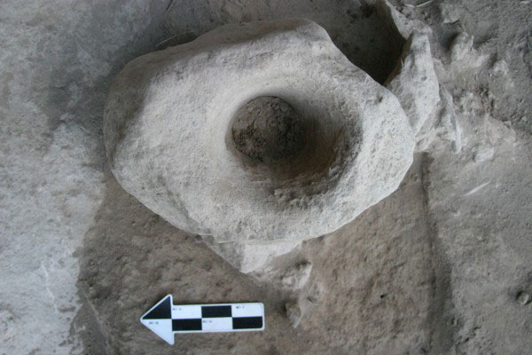 A boulder mortar found at the Natufian burial site in Rakefet Cave, Mt. Carmel. Courtesy: Prof. Danny Nadel.