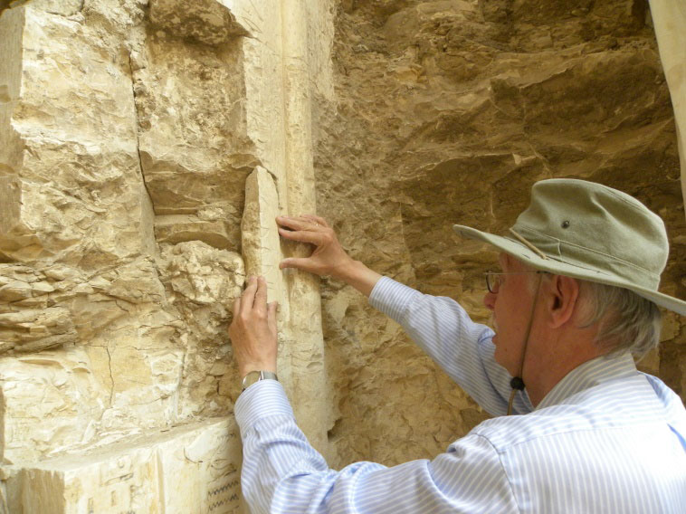 Erhart Graefe is placing a fragment on the doorframe of Padibastet. Photo Credit: South Asasif Conservation Project.
