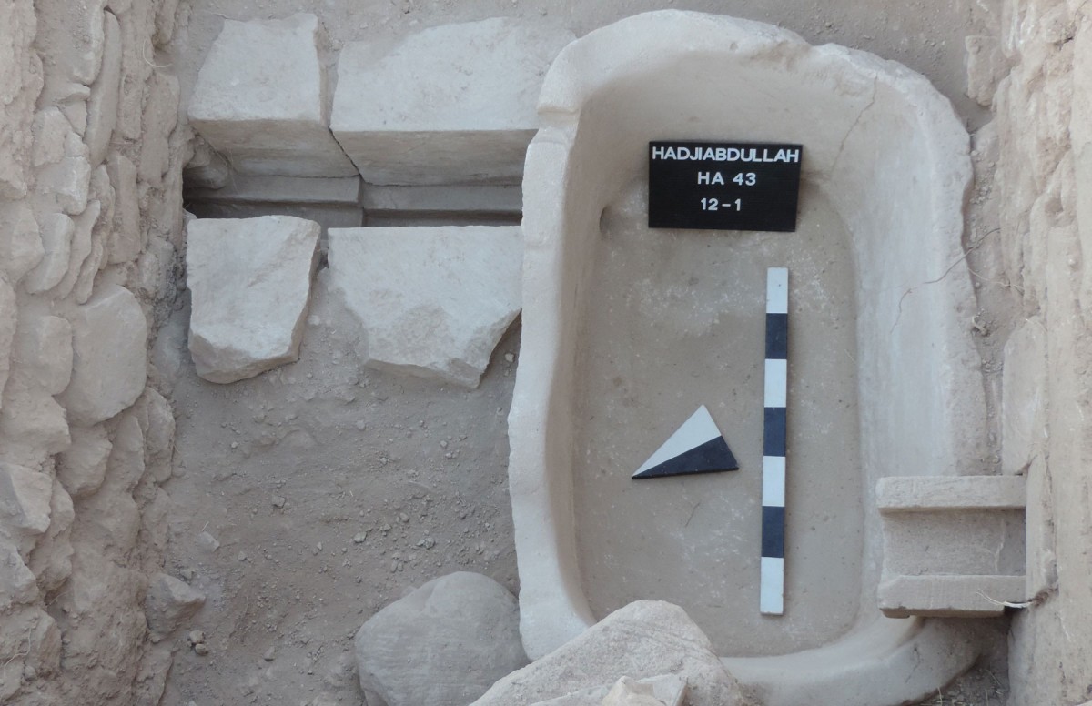Palaepaphos: Stone bathtub placed in a narrow passage between stone channels.