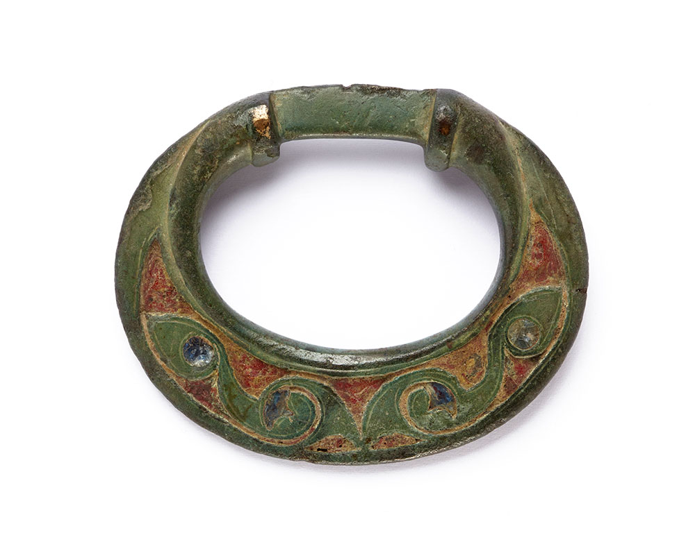Iron Age cast bronze terret with red and blue glass inlay from Suffolk. Photo Credit: Ashmolean Museum, University of Oxford© .