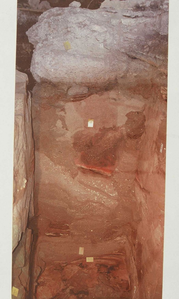 Fig. 6. Typical stratigraphy of cave’s embankments. The grey Neolithic embankment can be distinguished above, below the light coloured glacial sediments with inbetween improved climate and hearth and on the deepest level the Middle Palaeolithic embankments.