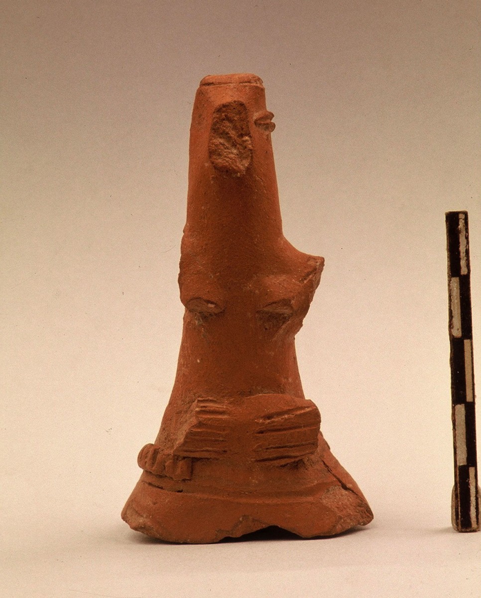 Fig. 36. Figurine with costume and hair drawn back in a bun. Its base being broken, it may have been used as the handle of a vessel’s stopper. Probably from the Chalcolithic period.  
