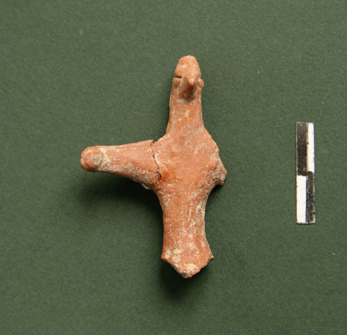 Fig. 42. Cruciform anthropomorphic figurine retaining features of its face and hairstyle. Missing one hand and its base, it was probably used as a handle on the stopper of a vessel. We estimate it copies similar gold prototypes from the Balkans. Chalcolithic period.