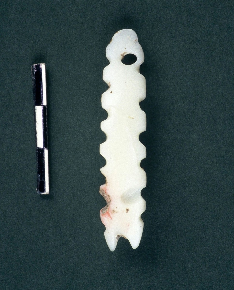 Fig. 44. Elongated cog shaped pendant with hole, made of the Spondylus gaederopus shell.