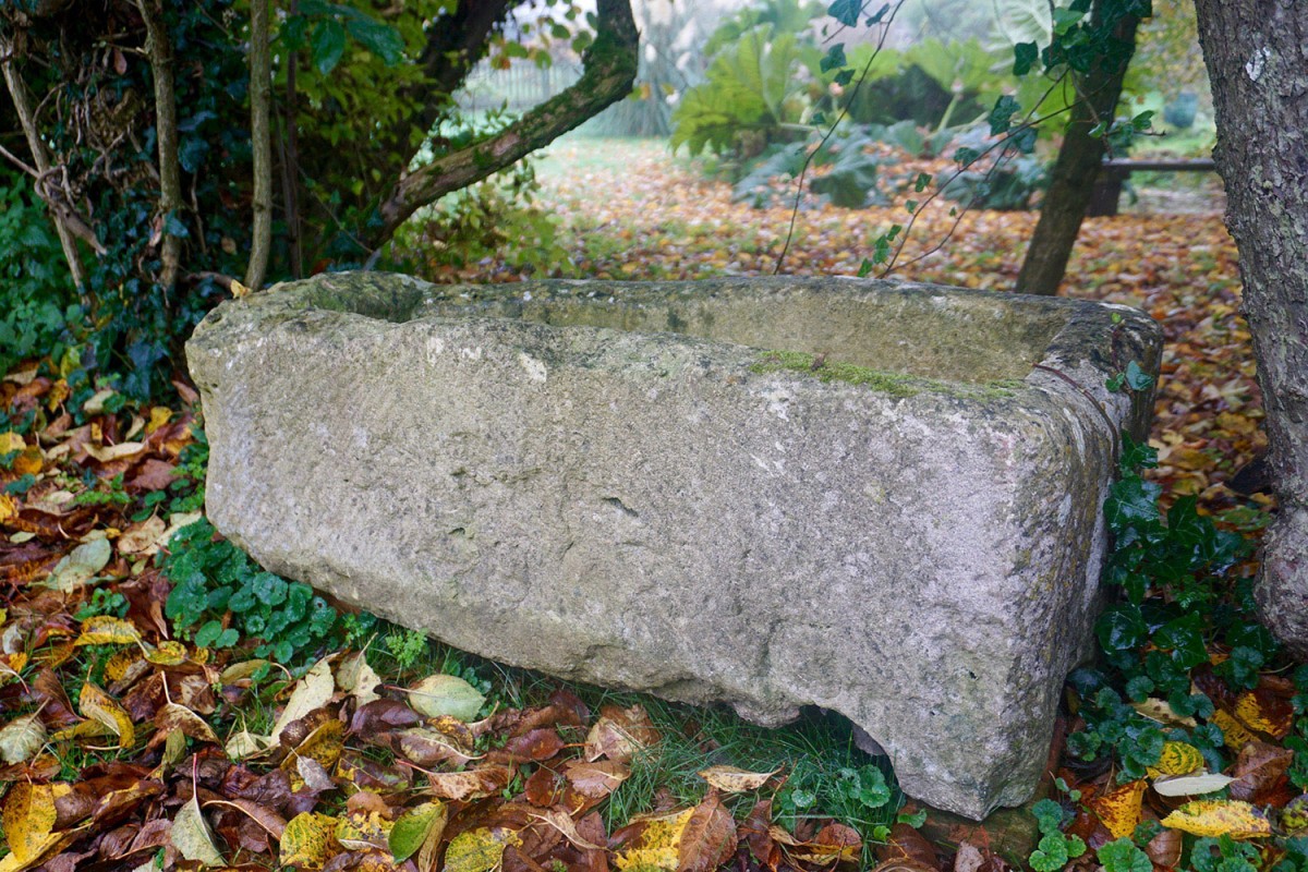 A stone structure that Luke Irwin had been using as a planter for his geraniums. Archaeologists now believe it to be a child’s coffin that may date from between A.D. 175 and 220. Photo Credit Jon Wilks/NY Times.