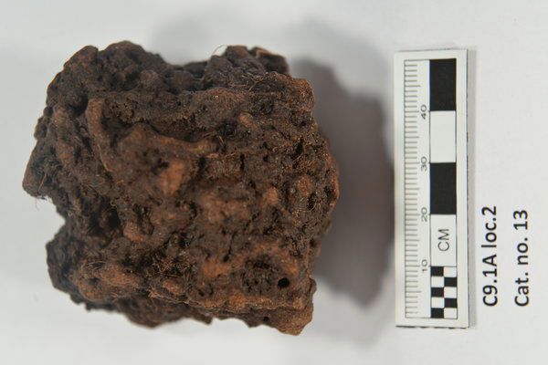 A lump of what scientists say is bog iron ore, and one of the samples being tested from the possible Viking site at Point Rosee. This roasted ore is a sign of metallurgy not associated with native people of the region. Photo Credit: Greg Mumford/New York Times.