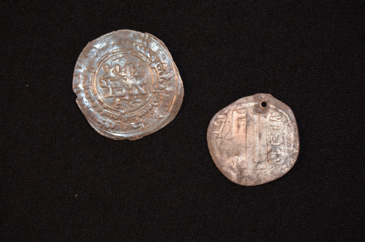 Two silver coins were also discovered on site. It is likely that they came from as far away as Afghanistan. Photo Credit: Museum Silkeborg/Science Nordic.