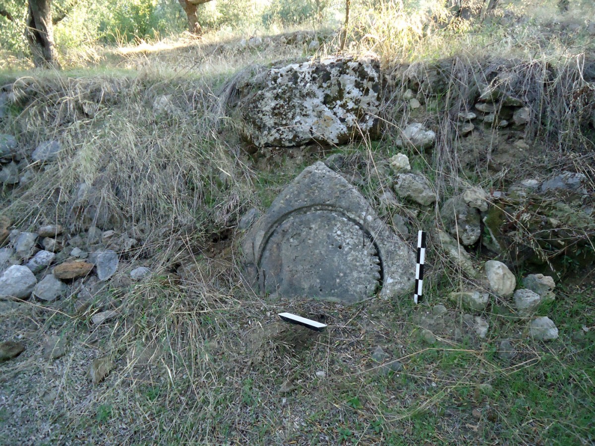 Fig. 7. “Hellenikon Monastery” in Thouria. Property of I. Filiopoulou. Base of oil press built into the modern dry stone wall. View from west.