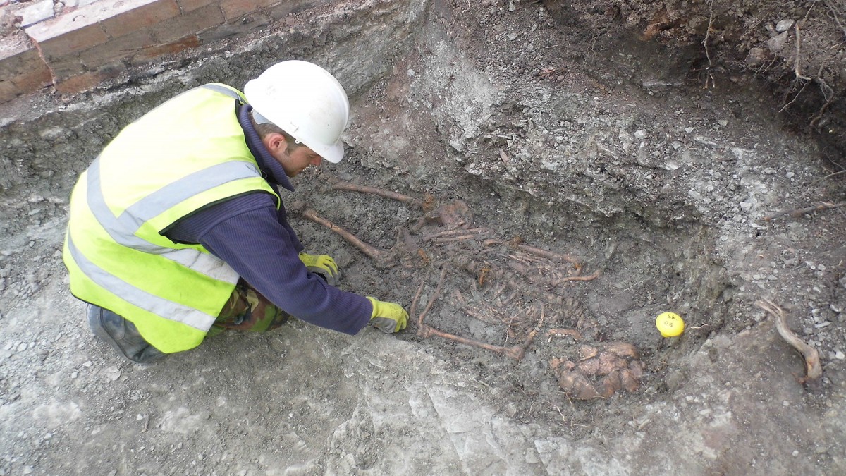 Fig. 1. An archaeologist excavates one of the skeletons in the Roman cemetery at Western Road. 