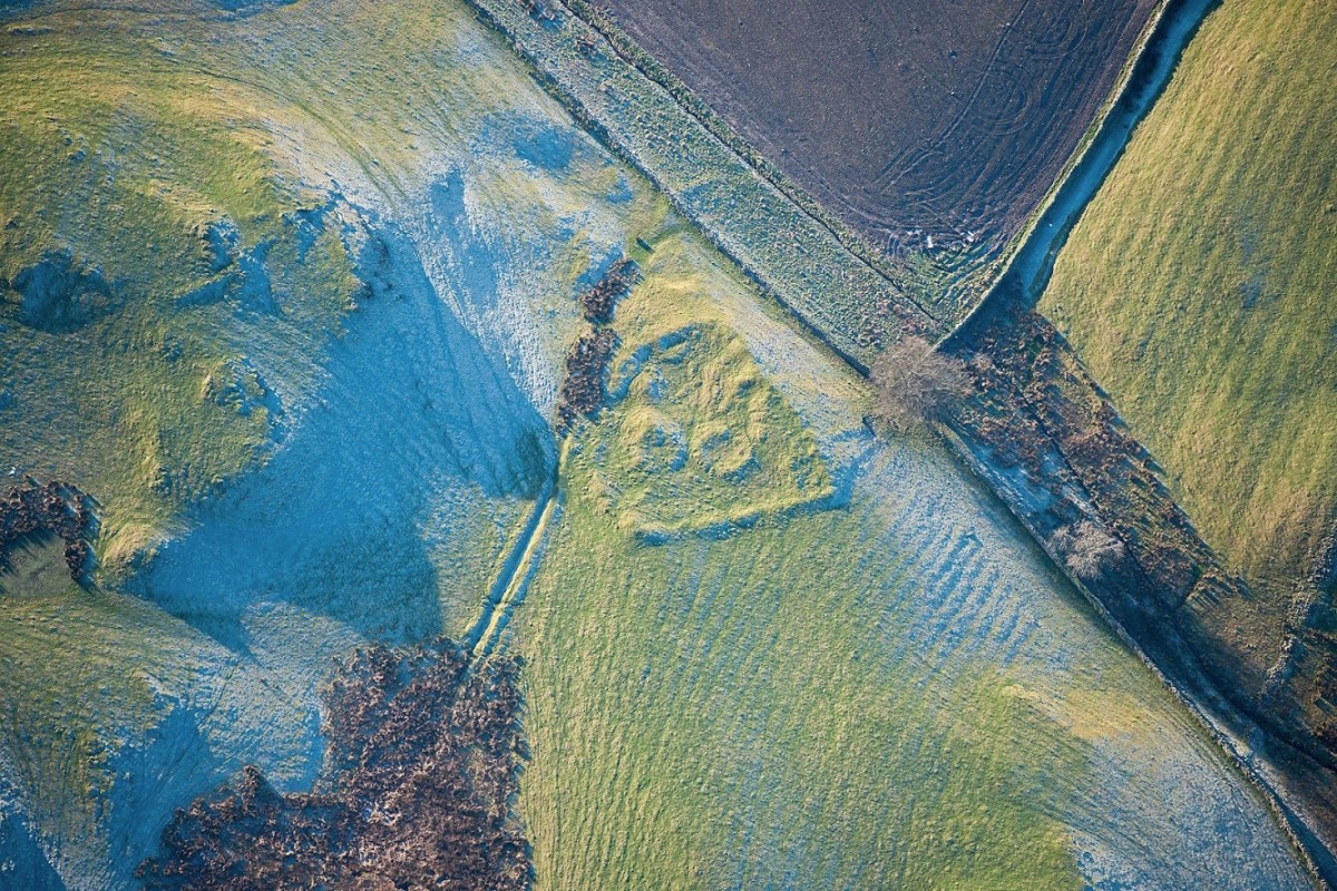 The low winter sunlight in this aerial photograph reveals subtle details of this late Iron Age or Roman settlement.