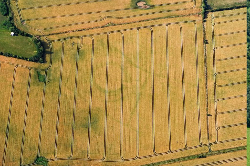 The buried remains of this rare and unusual prehistoric site were identified by Historic England’s aerial reconnaissance team during a dry summer.