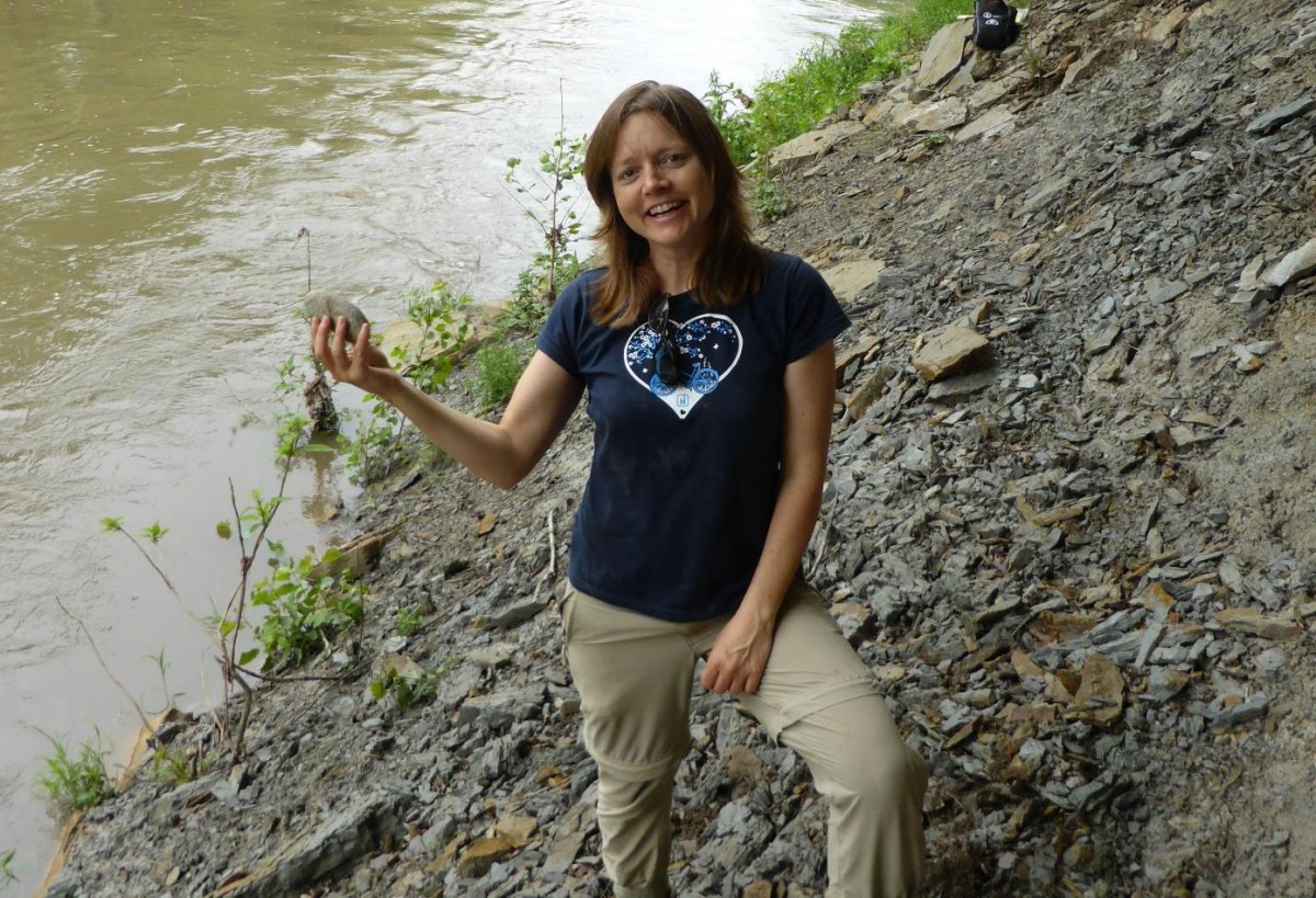 Professor Sarah Gabbott on fieldwork in Illinois digging for new fossil specimens. In her hand is a hard nodule formed 300 million years ago on a warm, shallow sea floor. 