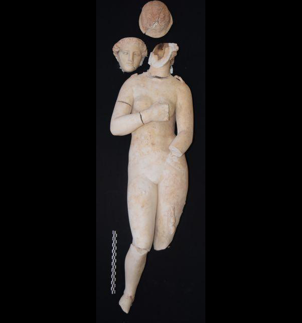 Marble statue of Aphrodite, the Graeco-Roman goddess of love, recovered at Petra in Jordan. A small Cupid on the lower right gazes up at Aphrodite. A handheld glass vial in visible on her left leg, probably from another figure now lost. The statue, about half life-size, probably dates to the second century A.D.
Credit: Tom Parker