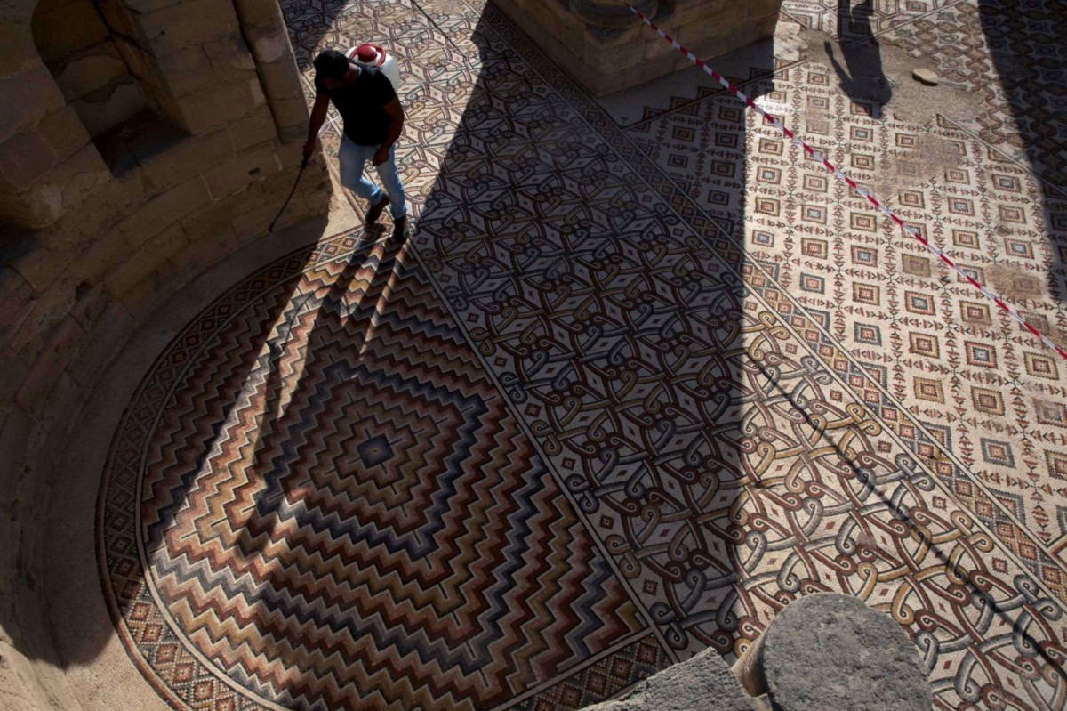 A labourer from the Palestinian Ministry of Tourism and Antiquities works at the site of the mosaic ahead of the opening ceremony at the Islamic archaeological site of Hisham Palace. Photo Credit: AP Photo/Nasser Nasser/Phys Org.