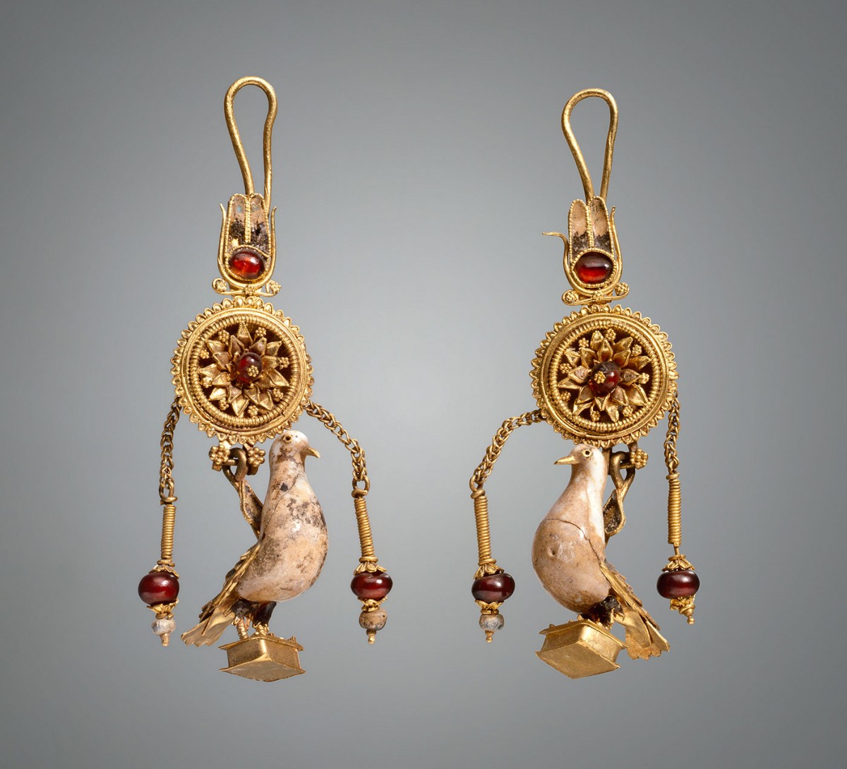 Earrings with pendants in the form of a dove. 2nd c. BC. Gold, hessonite, glass. Height 6.3/6.5 cm. Credit: State Hermitage Museum, St Petersburg.