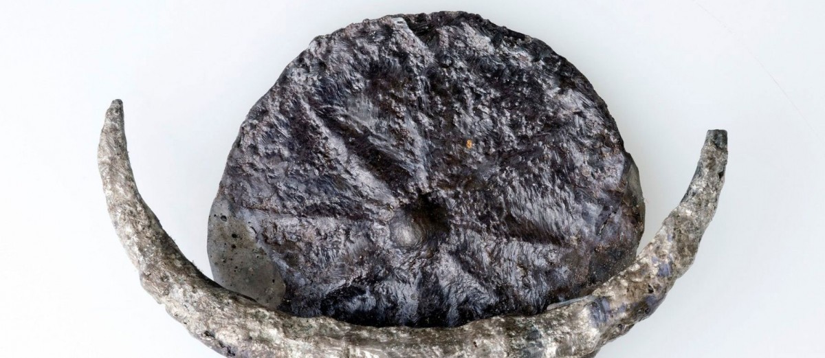 Silver pendant featuring a disc with a relief carving of an eight-pointed star, found in the biblical city of Gezer. Credit: Clara Amit, IAA
