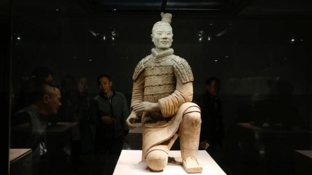 Visitors look at one of the Terracotta Warriors on display at the Terracotta Warrior Museum in Xian in north China