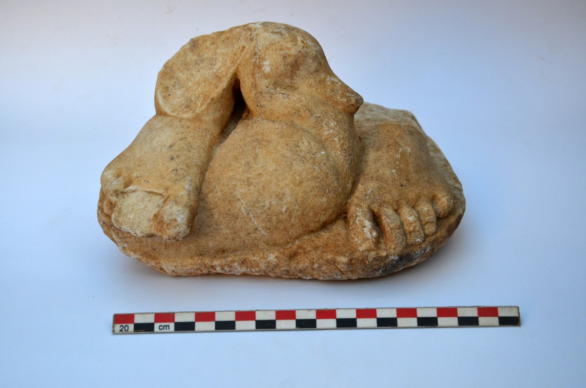 Building 1, Interior of the cistern: Fragment of a marble sculpture depicting a child and a duck. 