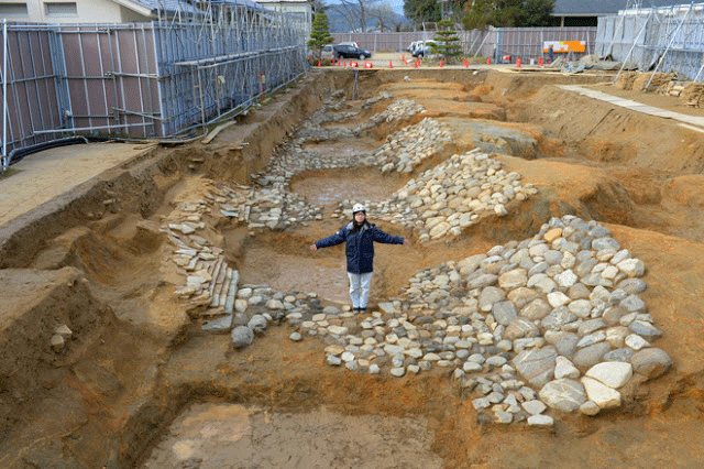 Remnants of a moat uncovered at the Koyamada ruins are covered by stones for about 50 metres. Photo Credit: Asahi Shimbun/TANN.