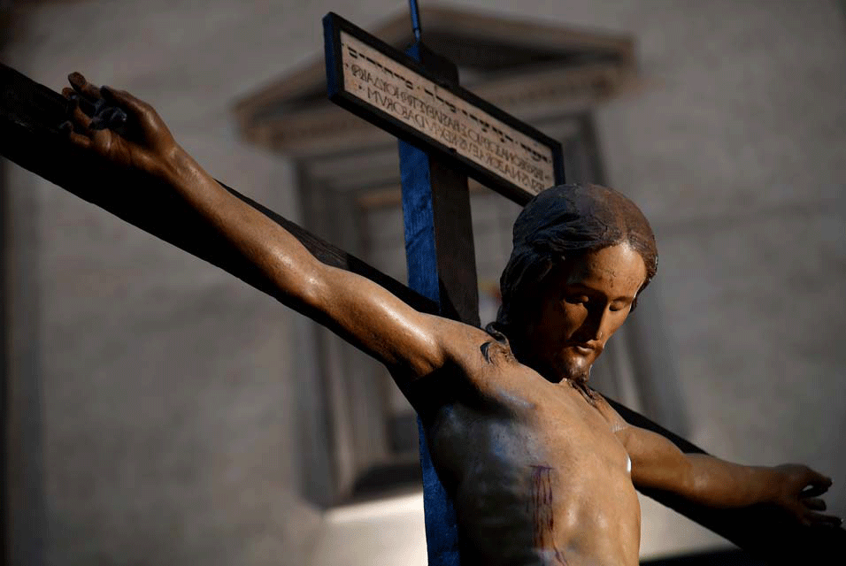 View of a wooden crucifix sculpted by Italian artist Michelangelo at the Santo Spirito basilica, on April 4, 2017 in Florence.  Photo Credit: Alberto Pizzoli/AFP/Art Daily.