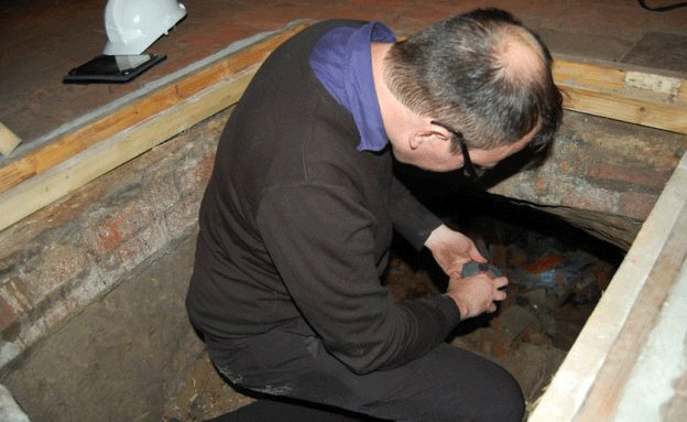 Scott Lomax accessed the cave through a hatch in the cellar floor. Photo Credit: BBC.