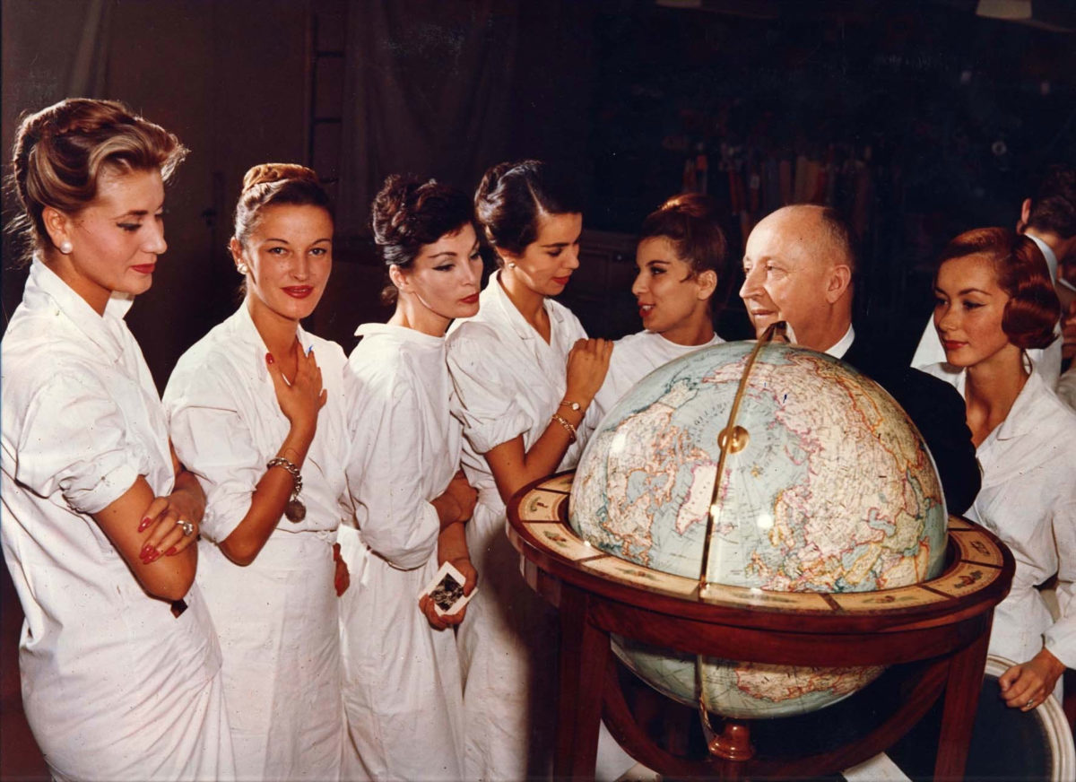 Christian Dior with his models, circa 1955 (photo: André Gandner.) 