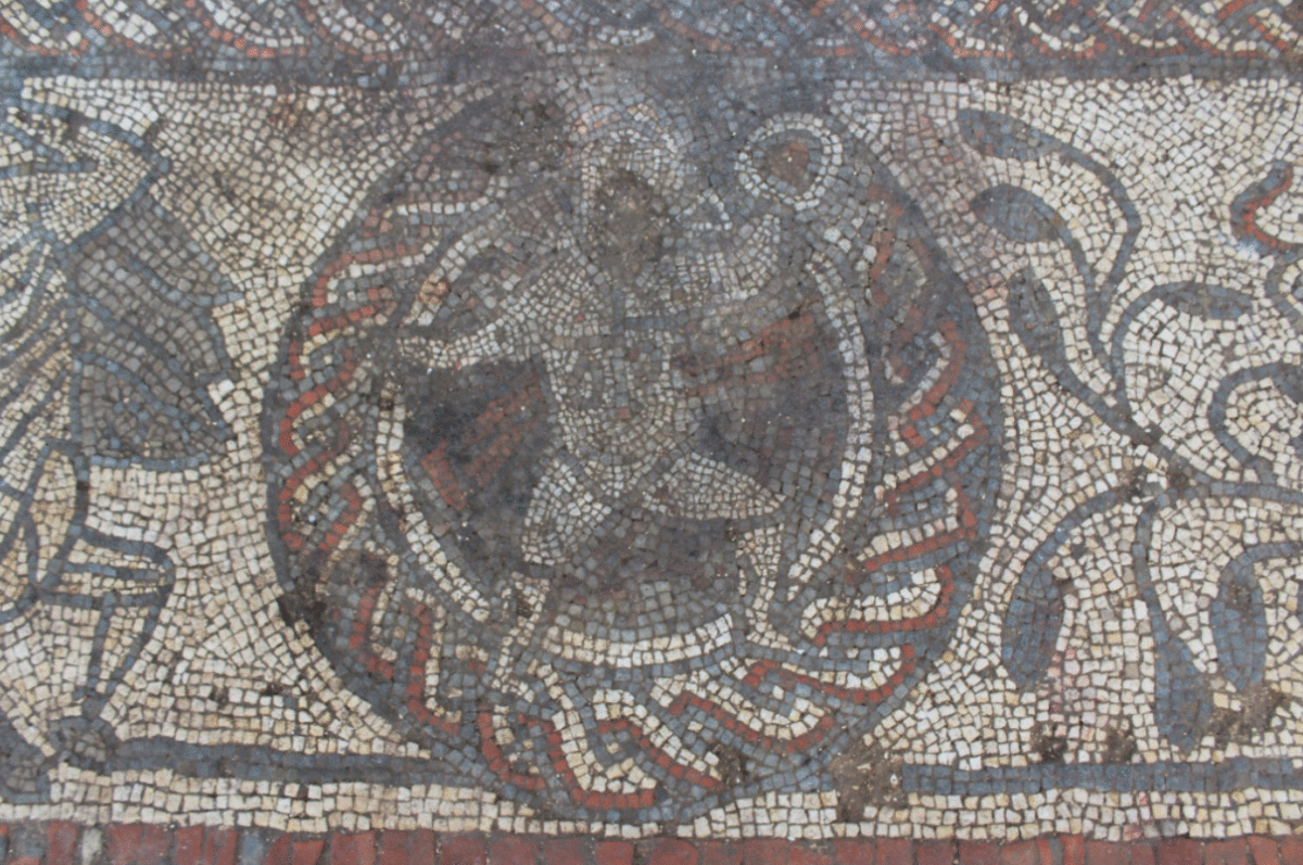 Cupid breaking out of his frame. Photo Credit: Cotswold Archaeology/The History Blog.