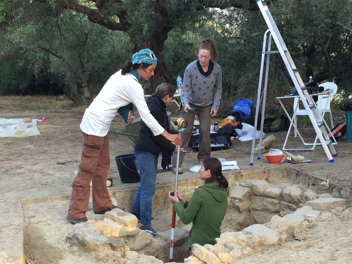 A UC team works to excavate the tomb of the Griffin Warrior.  From left are Denitsa Nenova, Shari Stocker and Alison Fields. Jonida Martini stands in the trench. Photo Credit: University of Cincinnati. 