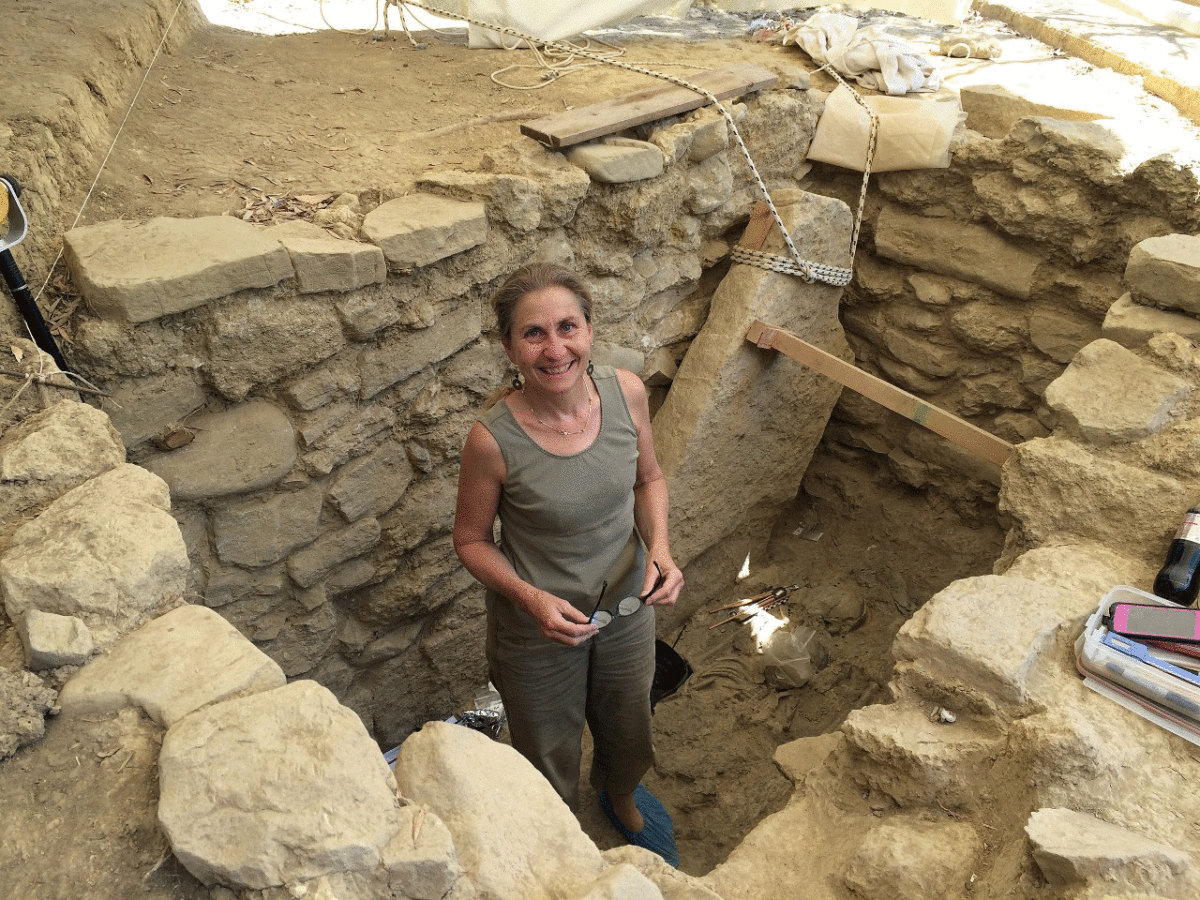 Shari Stocker stands in the grave of the Griffin Warrior discovered near the Palace of Nestor in Pylos, Greece. Photo Credit: University of Cincinnati. 
