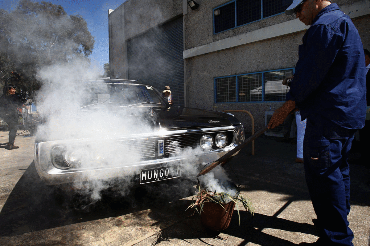 The smoking ceremony to purify the hearse. Photo Credit: Dean Sewell for the Guardian