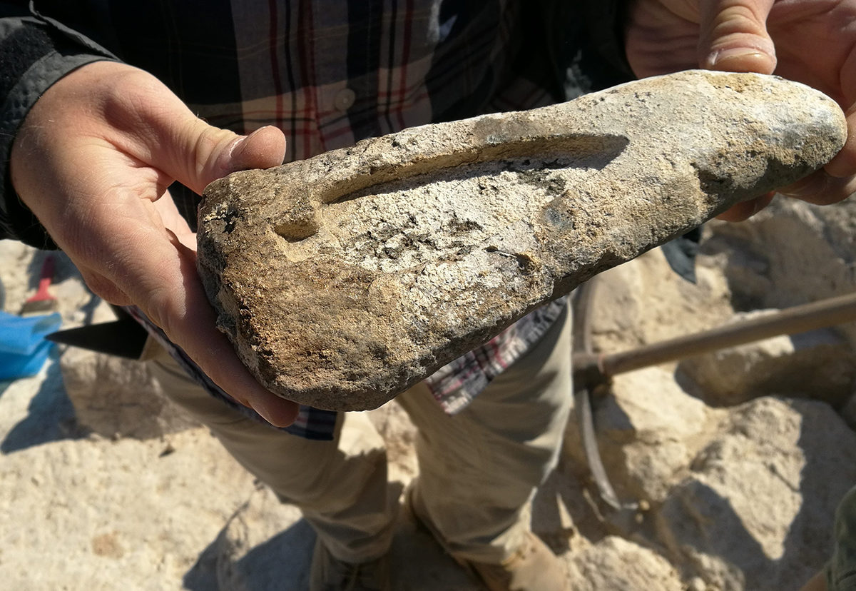 Mould for a copper spearhead, just after discovery during the excavation. Image credit: Cambridge Keros Project. 
