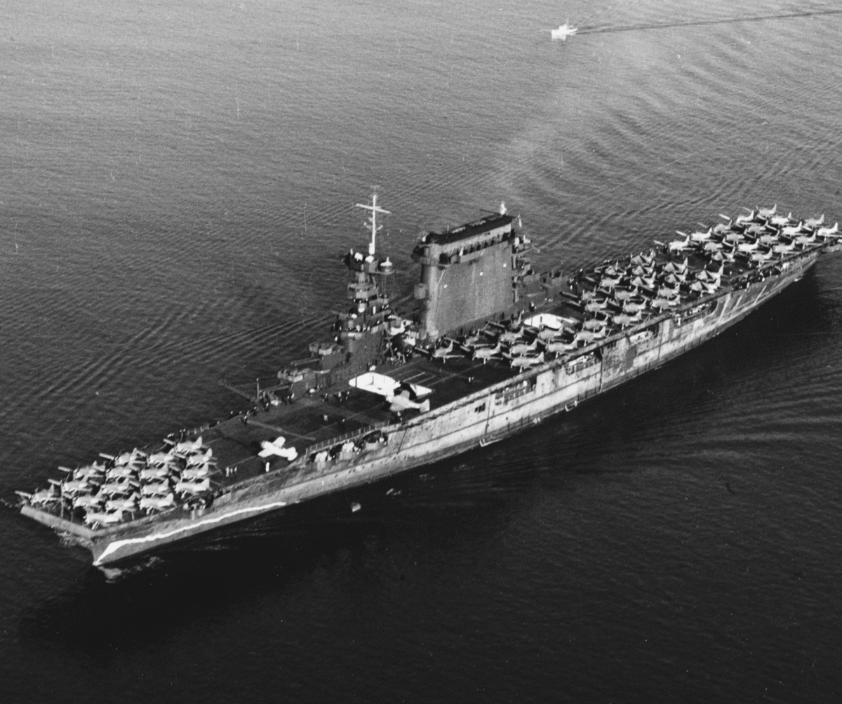The U.S. Navy aircraft carrier USS Lexington (CV-2) leaving San Diego, California (USA), on 14 October 1941. Planes parked on her flight deck include Brewster F2A-1 fighters (parked forward), Douglas SBD scout-bombers (amidships) and Douglas TBD-1 torpedo planes (aft). Note the false bow wave painted on her hull, forward, and badly chalked condition of the hull's camouflage paint. Photo Credit: U.S. Navy photo 80-G-416362/Wikimedia Commons.